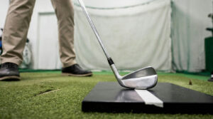 Iron on a lie board during a fitting, showing length and lie checks for golf clubs for tall golfers