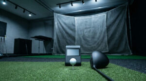 Portable launch monitor behind a teed ball in a fitting bay, launch monitor data explained